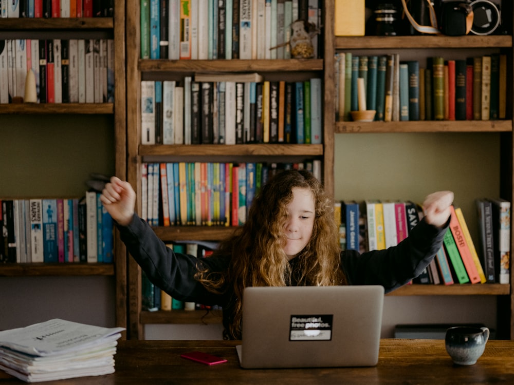A person celebrating at their laptop after a successful session